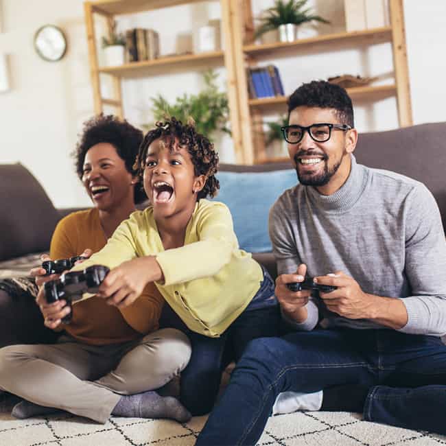 Family Laughing While Playing Video Games Together